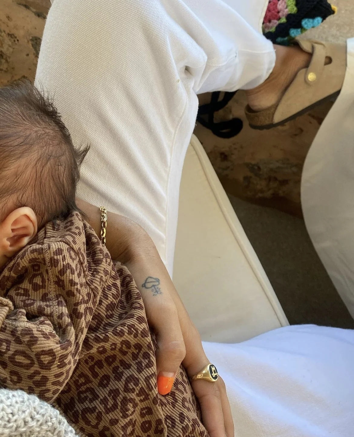 Baby wearing leopard wrap bodysuit made from GOTS cotton