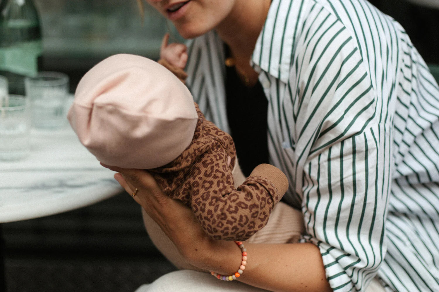 Close up of leopard print organic cotton baby wrap romper