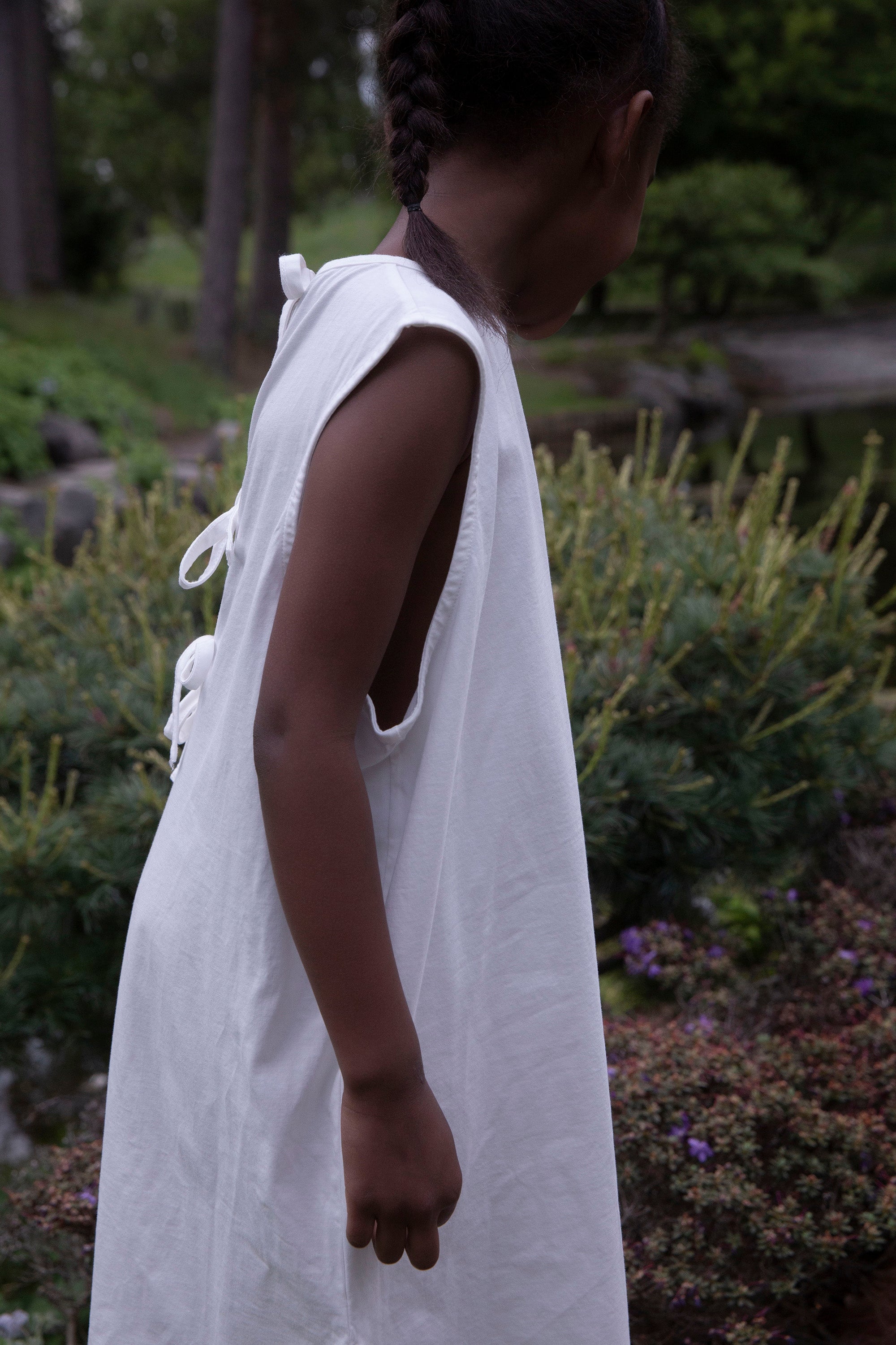 Child wearing Façade Raito No-Sleeve Dress, organic cotton sleeveless kids dress styled outdoors