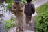 Children wearing Façade Kohi Wide Pants in hay, organic cotton kids trousers with a relaxed barrel fit, photographed outdoors by the water