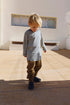 Child wearing Gray Label striped long sleeve in color blue grey