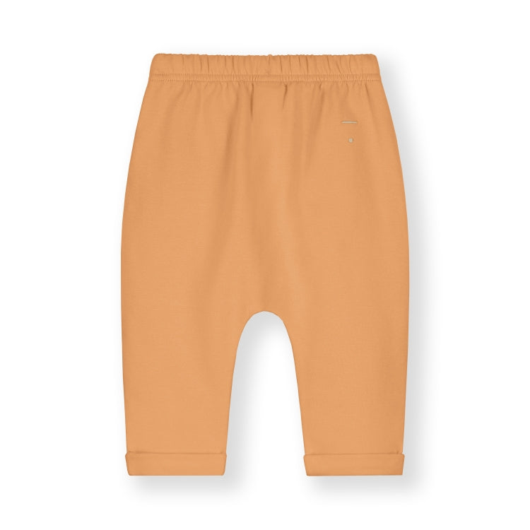 Organic cotton fleece pants made from GOTS-certified Italian fleece, shown in orange colour shown from thew back