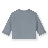 Organic cotton fleece raglan cardigan made from GOTS-certified cotton, shown in blue from the back