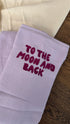 120x120 organic muslin giant swaddle in Lucky Lila with “To The Moon And Back” embroidery