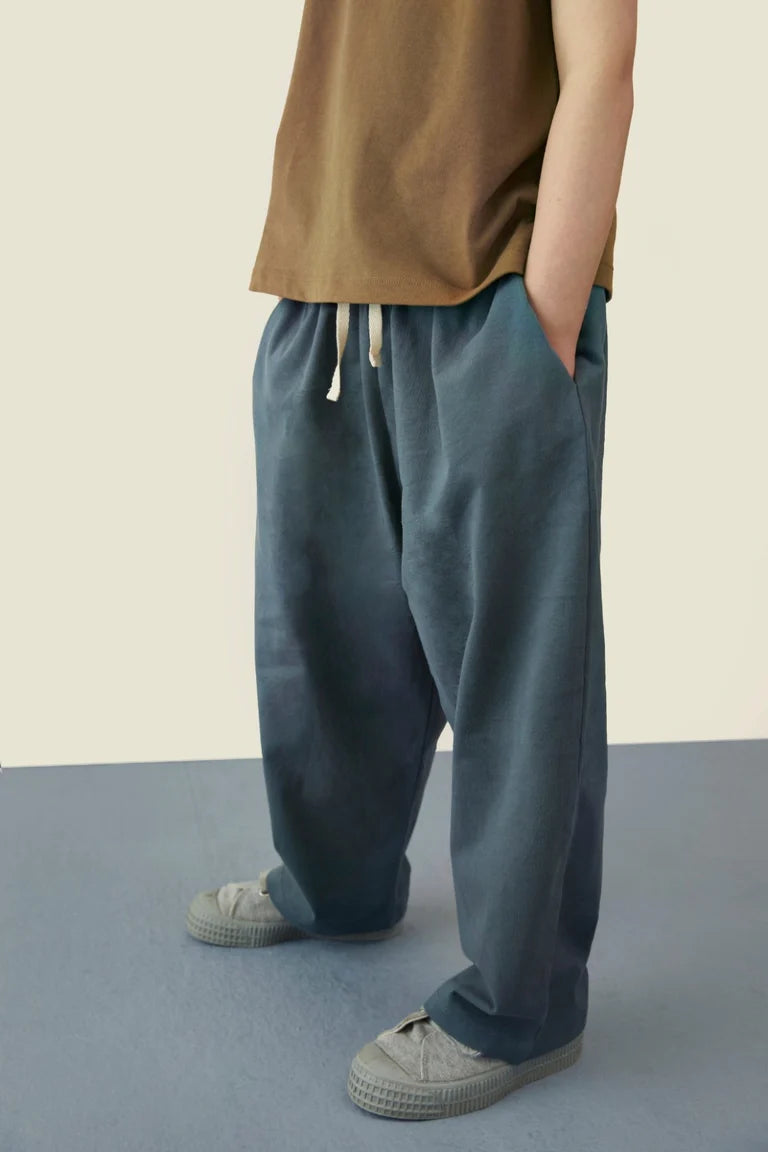 Child wearing Gray Label organic cotton pull up pants in blue grey