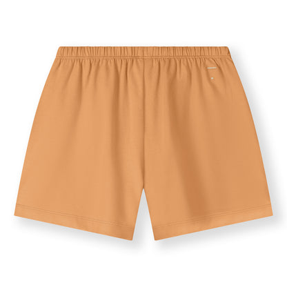 Organic cotton jersey shorts made from GOTS-certified cotton, shown in orange colour. Back side