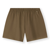 Organic cotton jersey shorts made from GOTS-certified cotton, shown in brown colour. Showing the logo on the backside. 