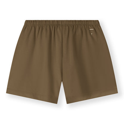 Organic cotton jersey shorts made from GOTS-certified cotton, shown in brown colour. Showing the logo on the backside. 