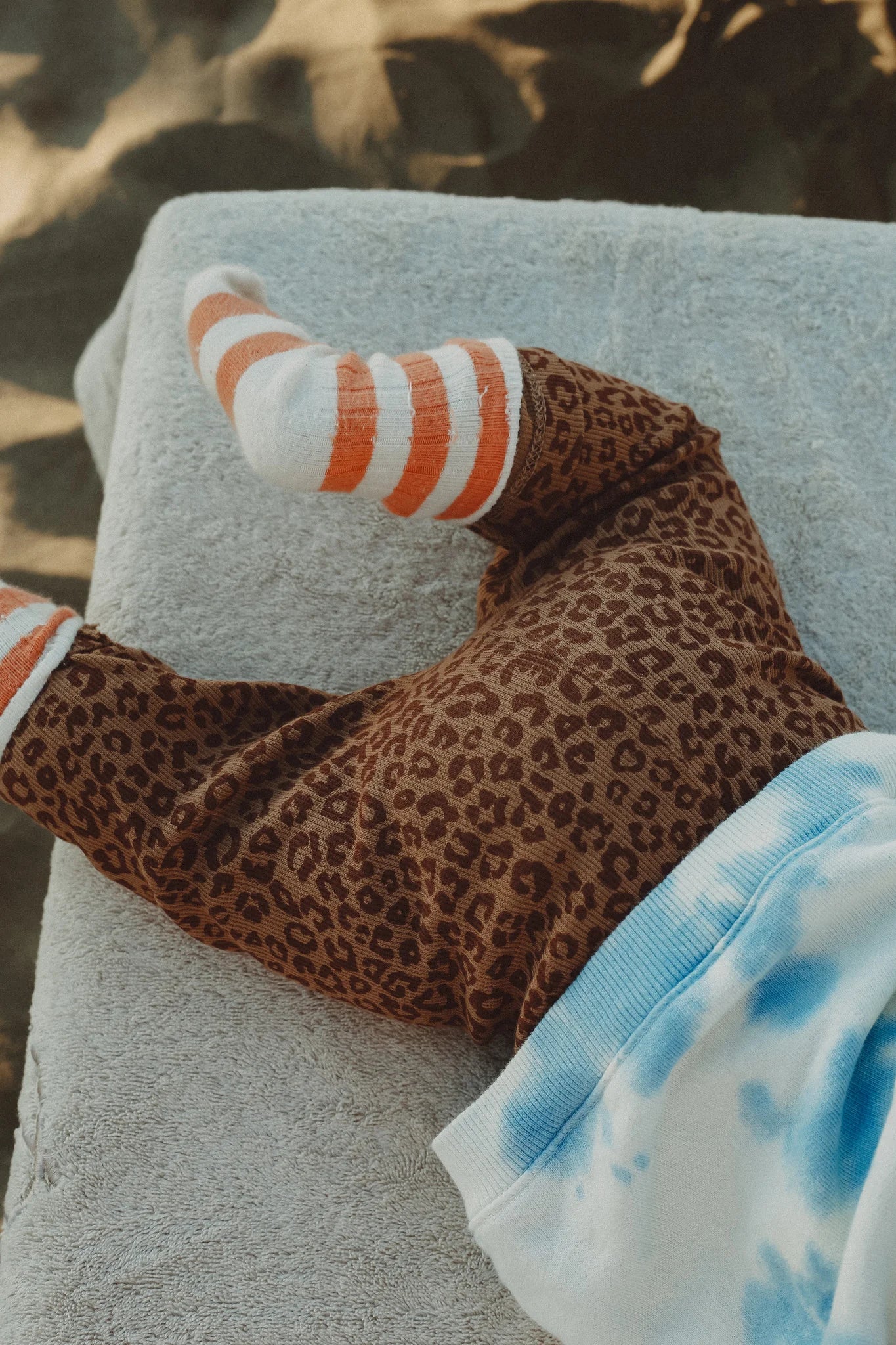 Baby in handmade leopard baby leggings crafted in Portugal
