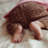Baby wearing handmade leopard print organic cotton pants by Atelier Pomme