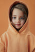 Girl wearing gray label hoodie in melon 