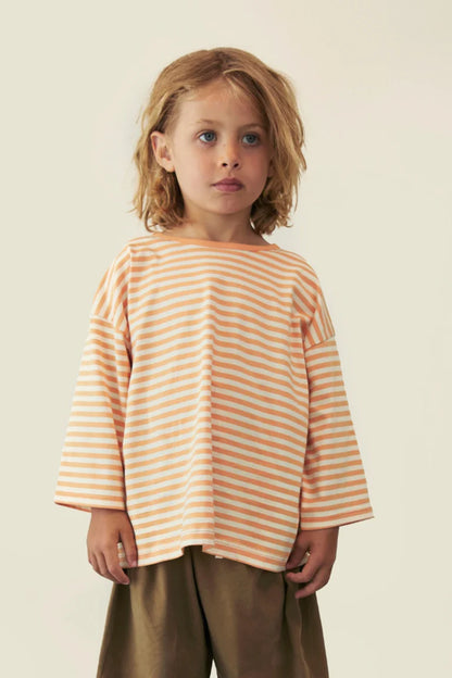 Child wearing Gray Label organic cotton oversized tee in Melon Cream