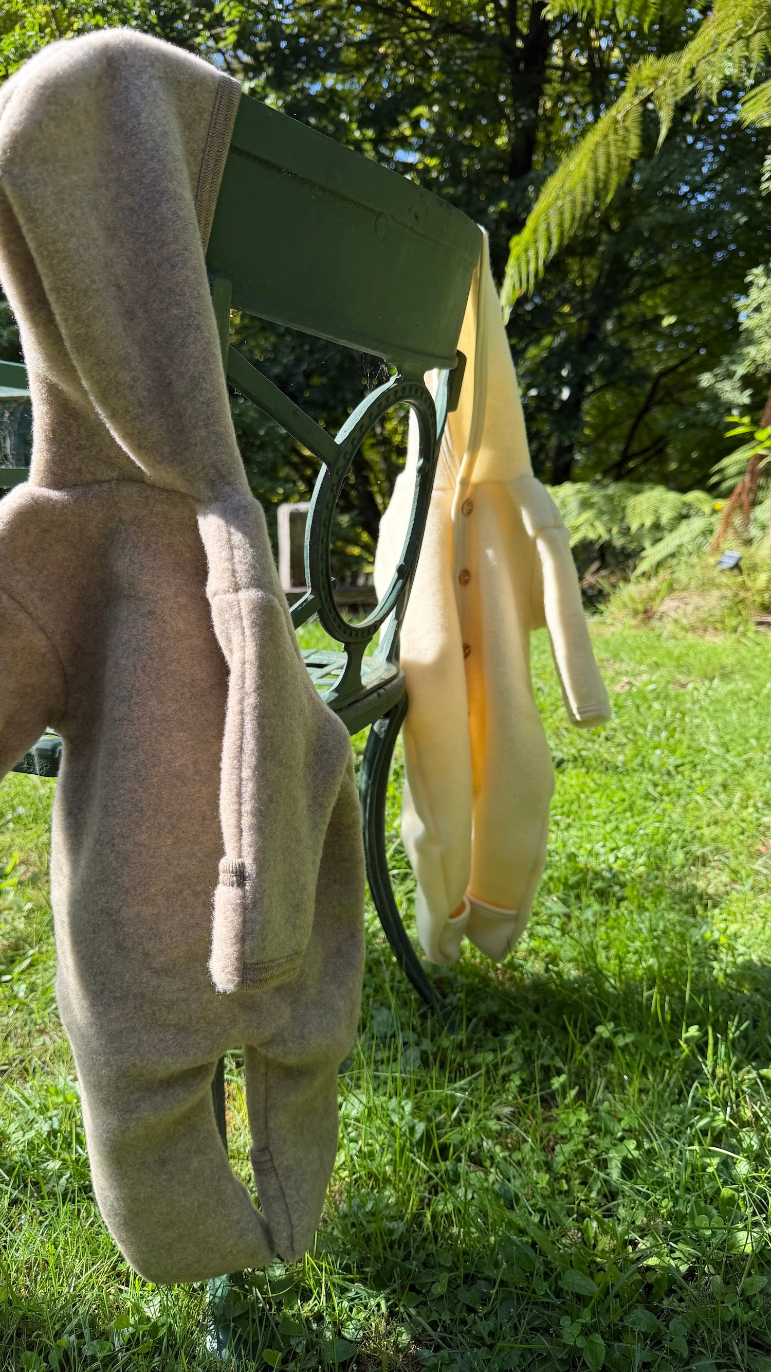 Engel Natur wool fleece overalls hanging on garden chair 