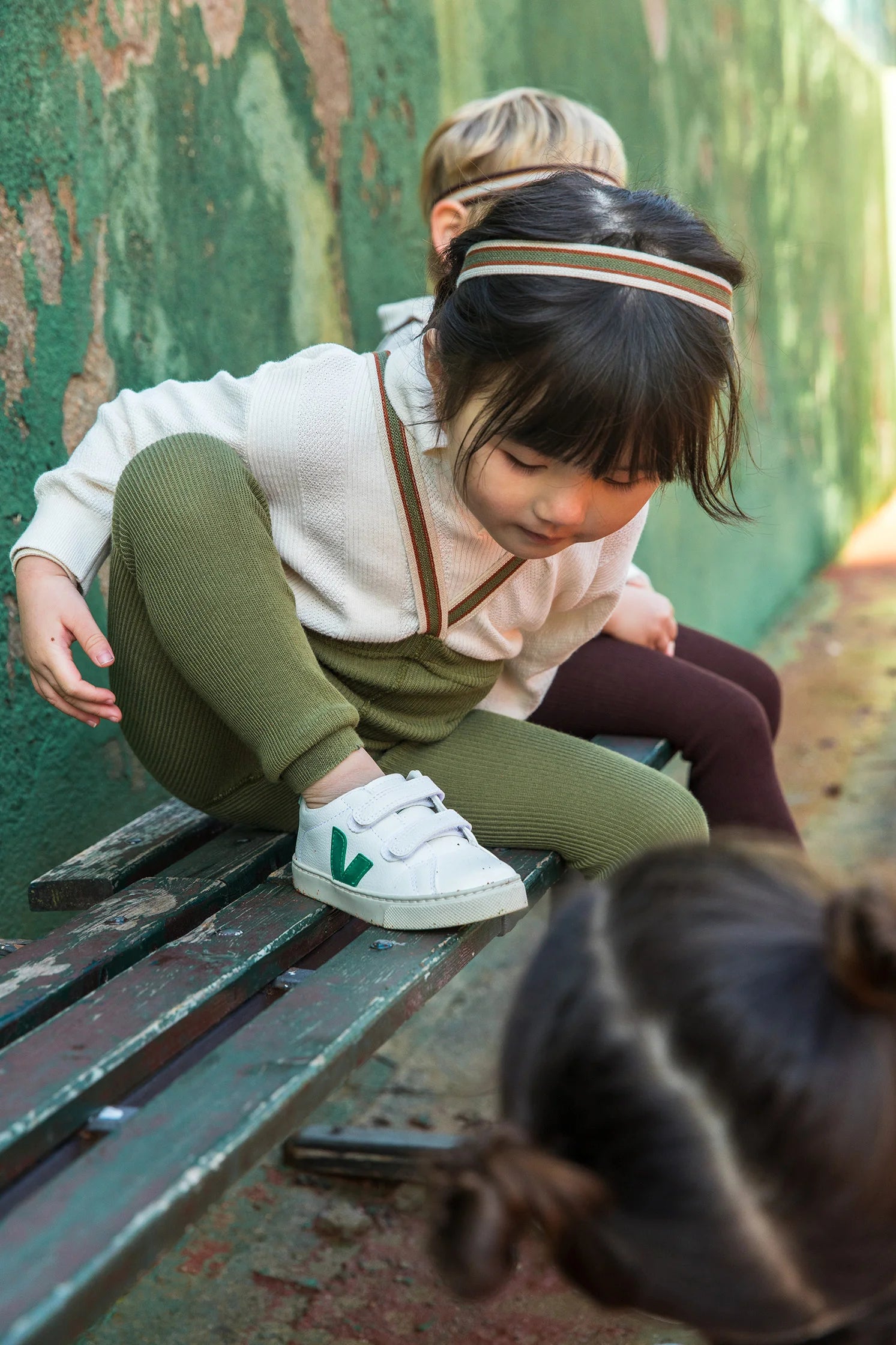 Toddler wearing Silly Silas footless tights with braces in Olive Stripe